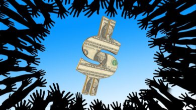 Hände die gierig nach Geld langen und entgegen der Selbstlosigkeit handeln