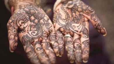 Two hand palms with brown tattoos