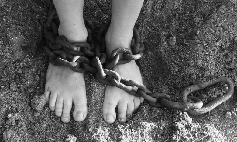 Two feet that are held in captivity showing us how to overcome sin and free us from slavery